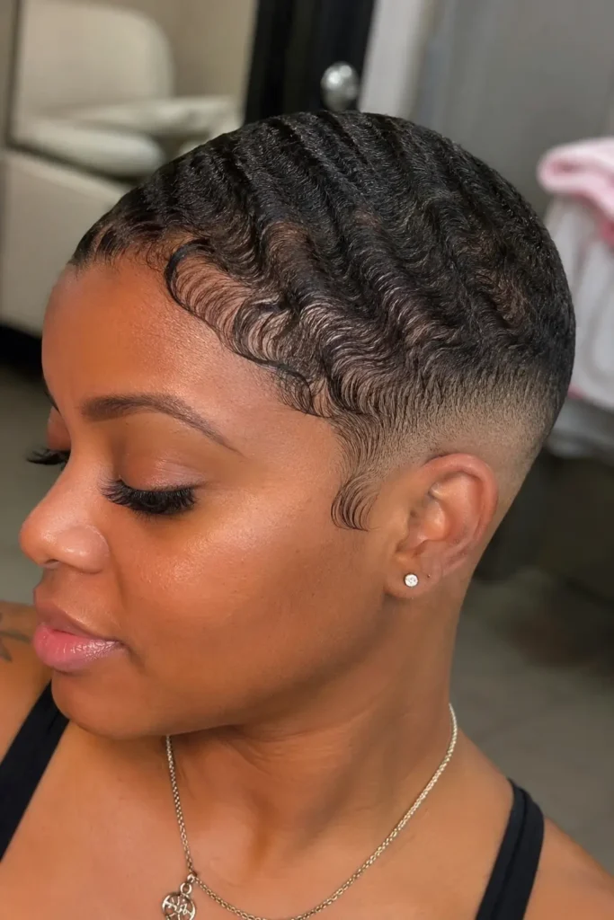 a Black woman aged around 25–35 with a bald fade haircut and defined finger waves, featuring realistic skin texture,