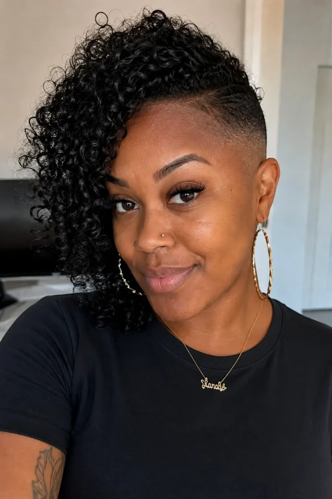 a Black woman aged around 25–35 with side curls and a bald fade hairstyle, featuring natural facial features and authentic skin texture