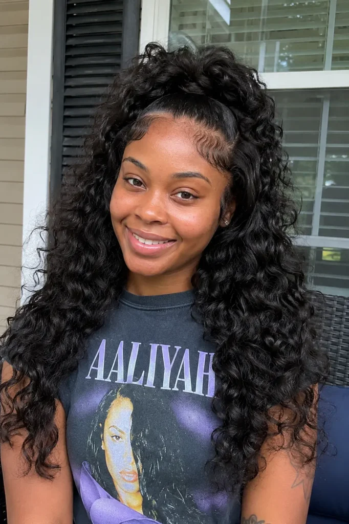 a real young woman with a half-up curly quick weave ponytail hairstyle featuring long, soft defined curls with natural movement and volume