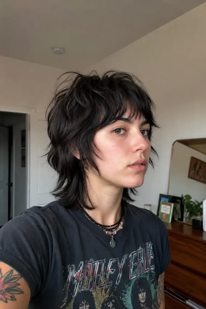 Short choppy wolf cut hairstyle on a real young woman with razor-textured layers, messy crown volume, and wispy bangs, captured in soft indoor natural lighting