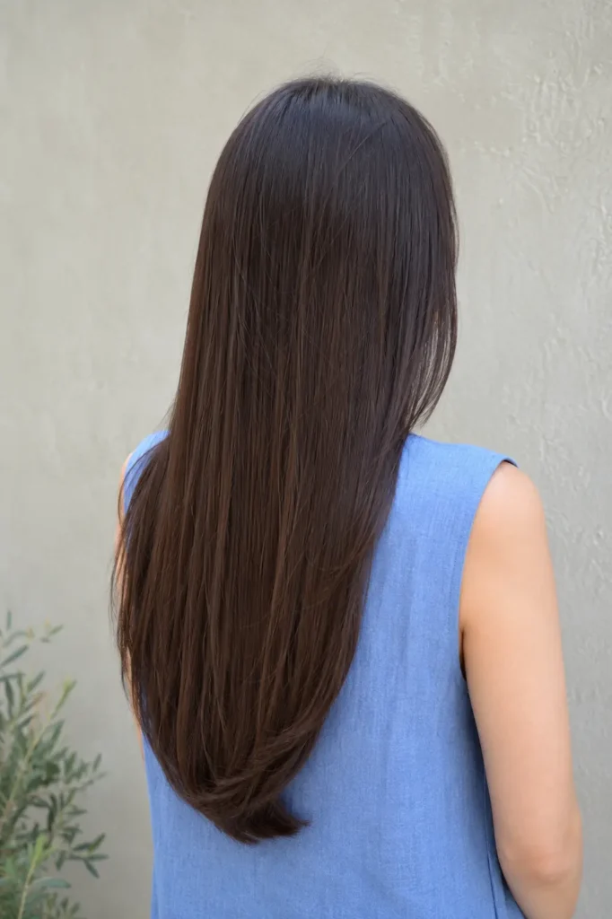 Long sleek straight hair with a soft U-shaped haircut