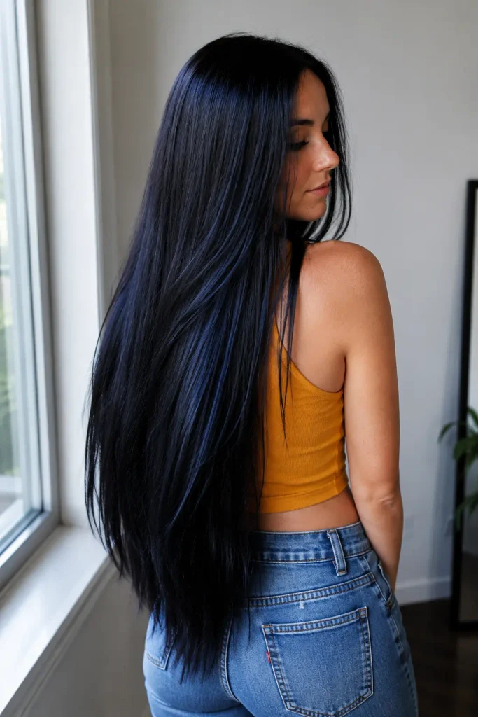 Soft black hair with subtle blue undertones, creating a sleek, glossy, cool-toned finish.