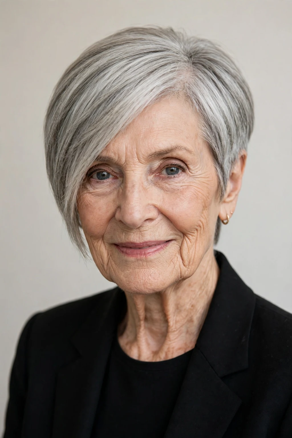 Elegant woman over 80 with asymmetric short cut, modern angled shape, confident light.