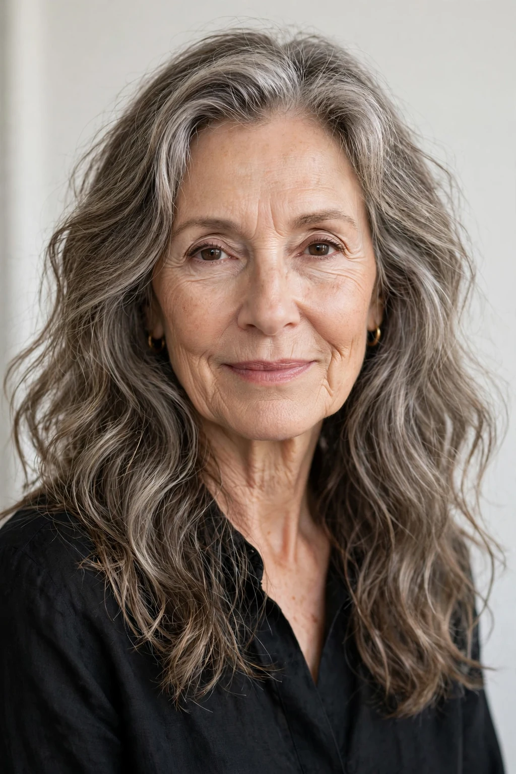Elegant woman over 60 with long air-dried texture, natural flowing waves, fresh light.