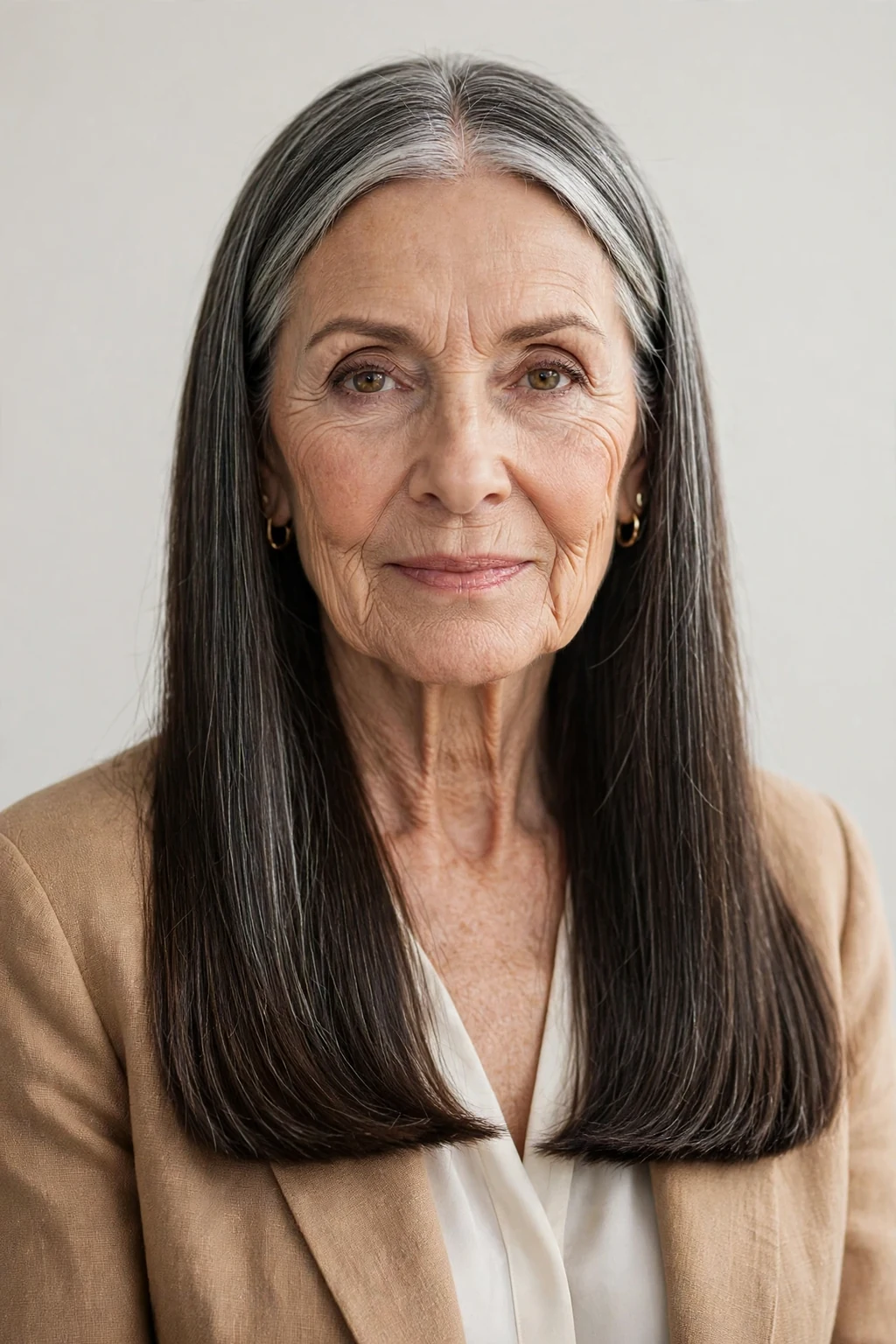 Elegant woman over 60 with long hair and blunt ends, sharp healthy ends, bold light.