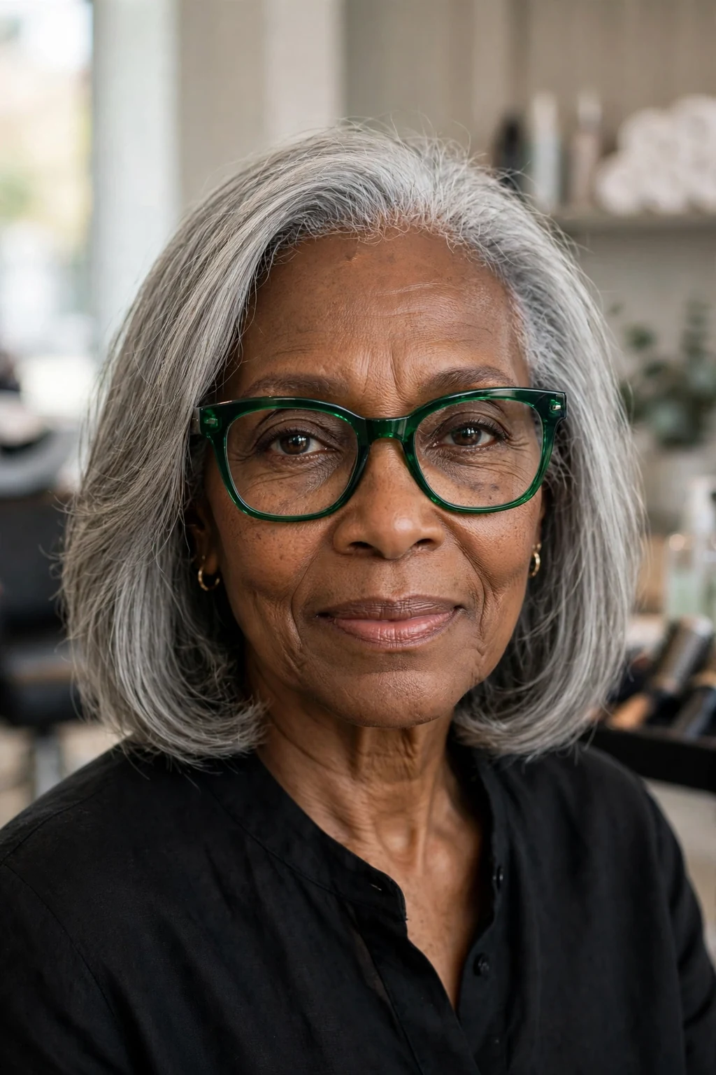 Elegant woman over 60 with fine hair and glasses and natural gray medium cut, luminous silver texture, stunning light.