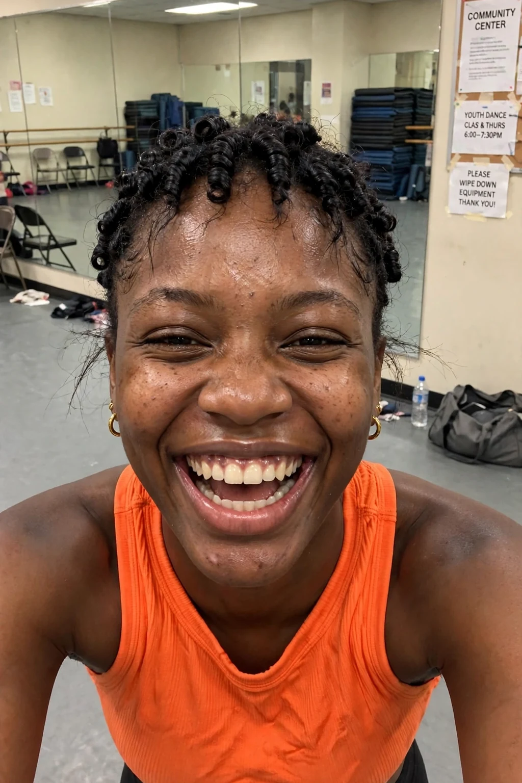 A young woman with a pixie haircut and defined finger coils covering the top.