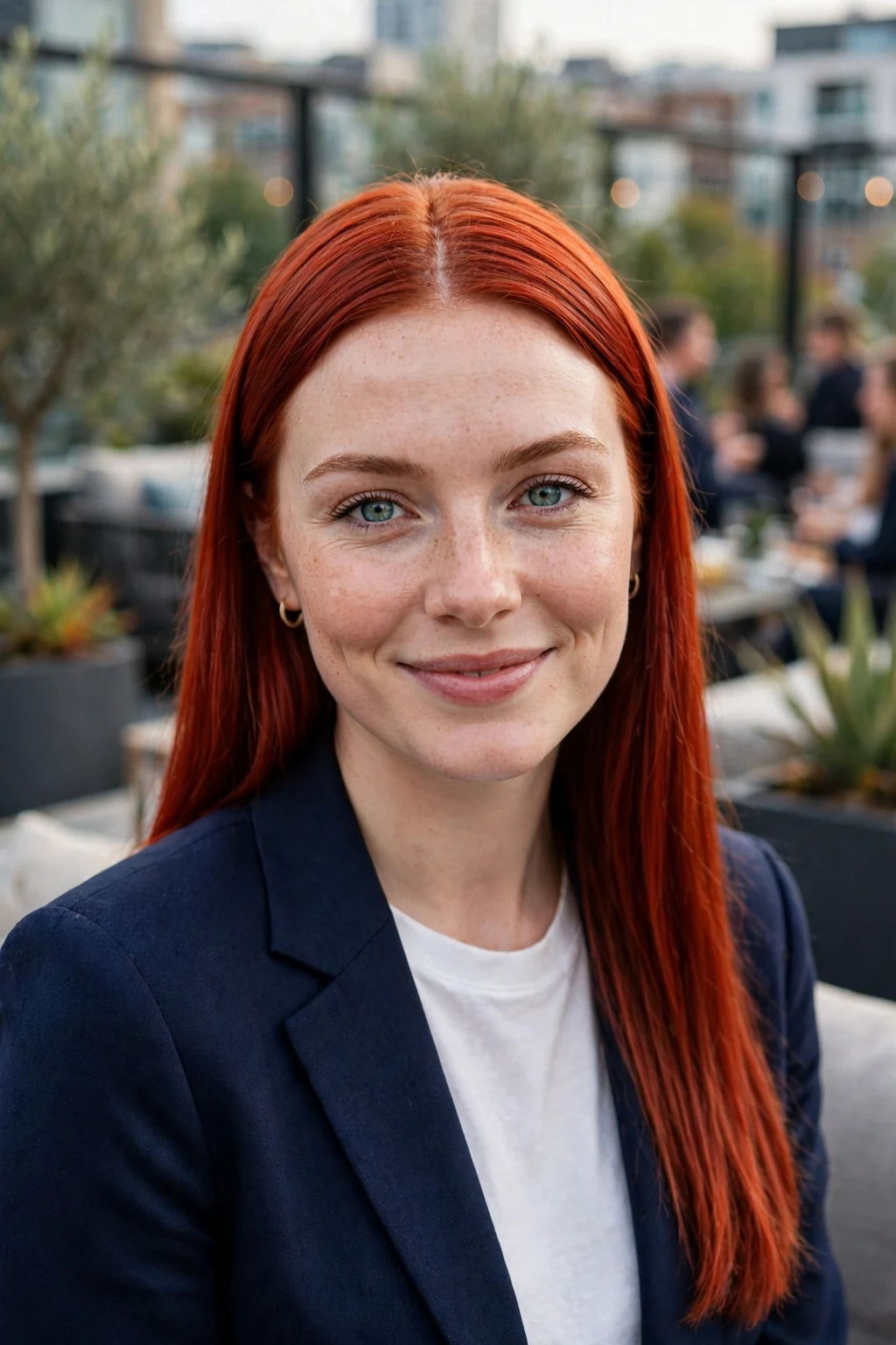 Young woman with sleek straight rocket red hair at a modern rooftop gathering.